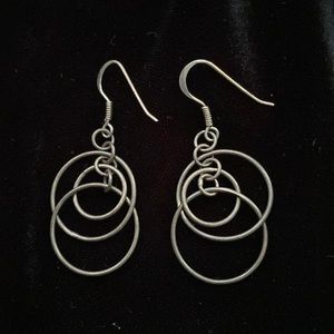 Silver circles dangling earrings.